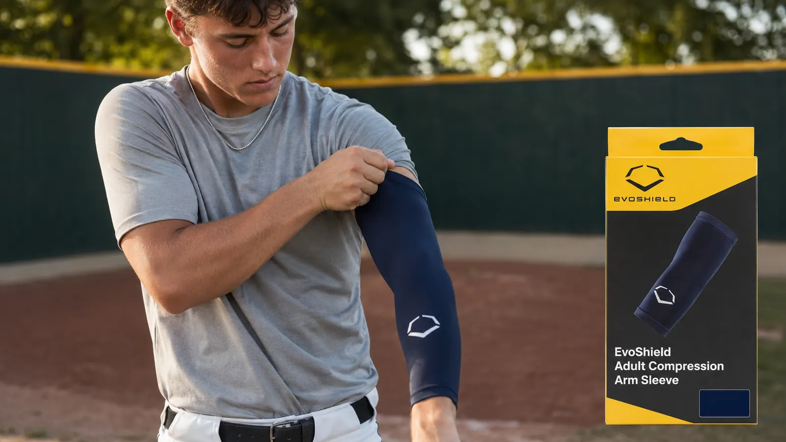 Teen pitcher pulling on an EvoShield compression arm sleeve before warming up in the bullpen